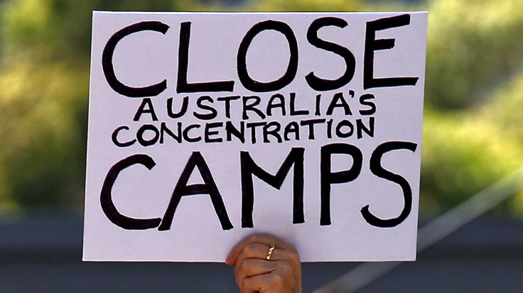 A protester holds a placard in support of refugees during a rally in central Sydney, Australia
